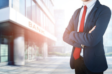 Young businessman on bank background
