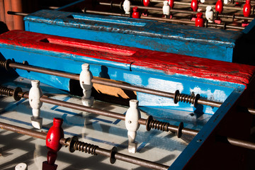 Ancient old wood classic aged Foosball table or table soccer with vintage effect photo style. Mini football close up concept.