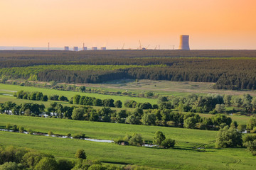 Fototapeta na wymiar Nuclear power plant pollution green field