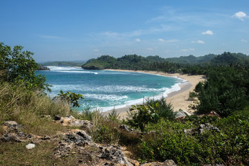 tropical bay with white sand at wediombo, java island, indonesia
