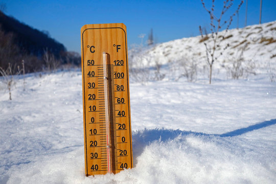 thermometer, snow and winter landscape
