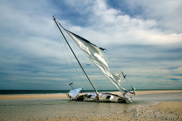 The yacht is shipwrecked and thrown ashore, torn sail. Gulf Coas