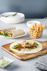 shredded barbecued chicken wraps with carrot, cheese, avocado an