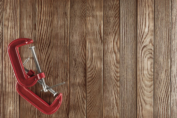 red clamp on the old wooden background