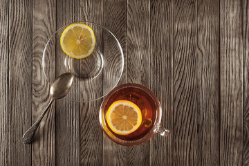 tea with lemon on a wooden table with wildflowers