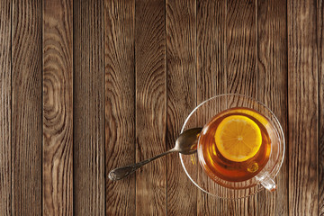 tea with lemon on a wooden table with wildflowers