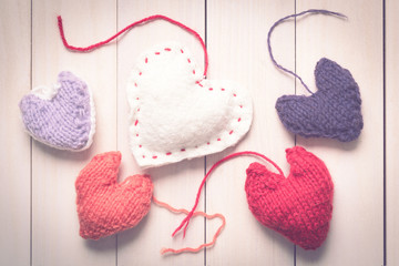 Valentine's Day. Colorful knitted hearts. Valentines day. Heart pendant. Red heart. Handmade Hearts. Valentine cards. Space for text. Toned image.