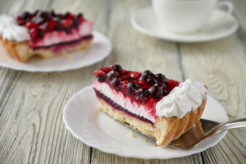 Cake dessert with cream, currants, cherries and coffee
