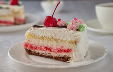 Delicious cake dessert with cream, cherries and coffee