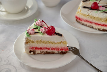 Delicious cake dessert with cream, cherries and coffee