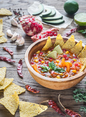 Mexican tortilla soup on the wooden background