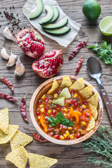 Mexican tortilla soup on the wooden background