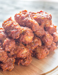 Fried chicken wings on the wooden board
