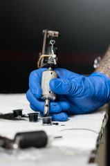 Tattoo artist making tattoo, focus on tattoo instrument