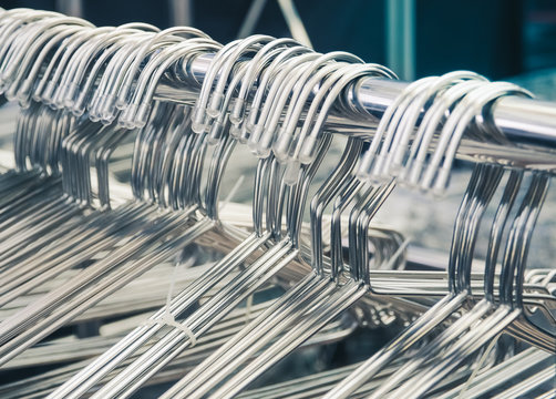 Selective Focus And Close Up/ Group Of Silver Clothes Hangers. Fashion Concept Image