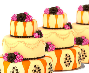 Three tier cake with 3 layer decorated chocolate rose and flowers. Group of three birthday or wedding tired pie orange and yellow slice for event or holidays on white background. Sweet food on dish .
