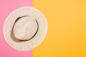 Woman's accessories flat lay on colorful background. Top view. Pink and yellow pastel colors with copy space around products. Horizontal image or photograph.