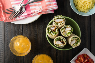 Breaded Chicken burrito Wrap With Fresh Lettuce Cheese on rustic