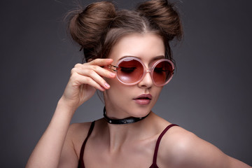Fototapeta premium Portrait of a beautiful girl. With beautiful makeup on a gray ba