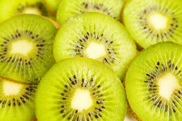 Fresh fruit kiwi and cranberries closeup of a flat background