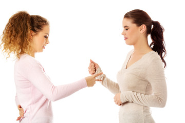 Two young girl friends standing together.