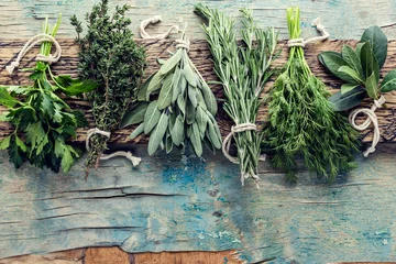 Wall murals Aromatic fresh herbs on wooden background with space for text