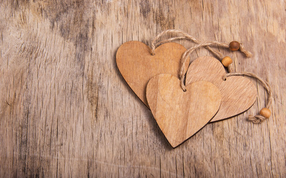 Hearts made of wood in the old worn wooden background. Wooden valentine. Valentine's day. Copy space