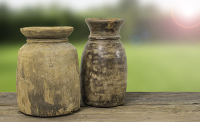 Rustic wooden vases with nature background.