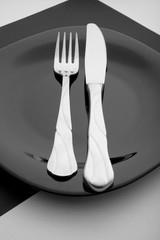 knife, fork and plate on a white background