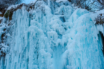 Fototapeta na wymiar Frozen waterfall in carpathian mountains