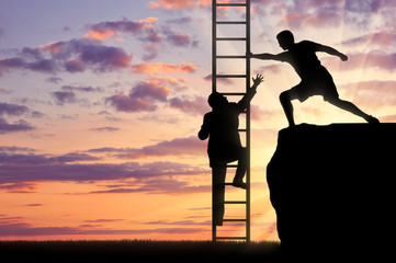 Man helps a person to climb the stairs