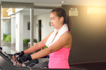 Fototapeta na wymiar fitness girl exercising on a cardio machine