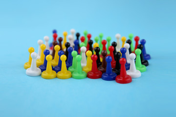 Colorful play figures. Board game pieces on blue background.