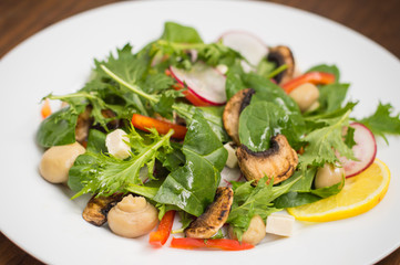 Fresh spring salad. Wooden background