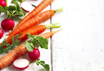 Spring vegetables on white wooden background with copy space. Ca