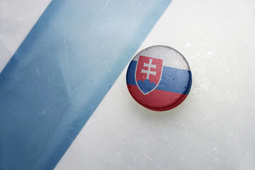 old hockey puck with the national flag of slovakia.