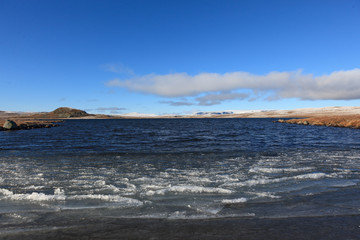 A cold autumn day with ice on the water on Hardangervidda, Norway