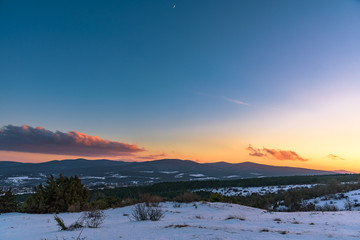 Colorful winter sunset on the mountain background with a spectacular sky. Russia, Stary Krym.