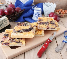 Tart flambee with purple onions, bacon and apples (Flammkuchen), selective focus