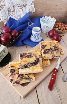 Tart flambee with purple onions, bacon and apples (Flammkuchen), selective focus