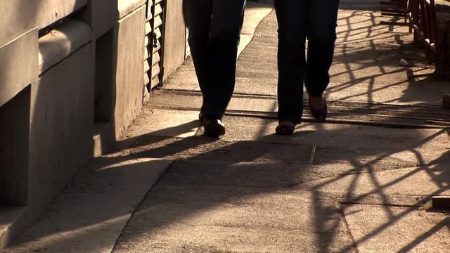 two people walking the pavement