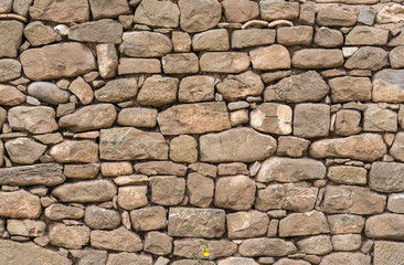 Old stone wall stones fitted together without cement, carved by hand