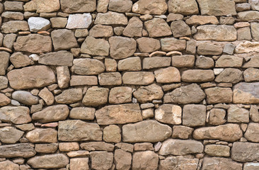 Old stone wall stones fitted together without cement, carved by hand