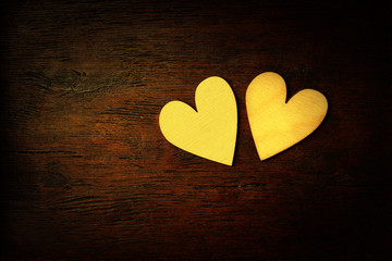 Lovers of the heart on a wooden background. Dark style vintage processing