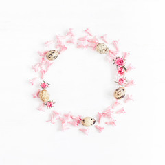Easter wreath made of quail eggs and flowers. Easter frame. Flat lay, top view