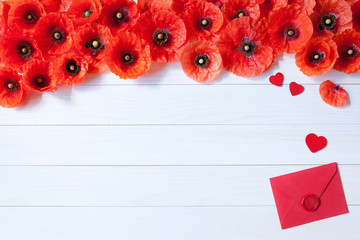 Wooden background with red flowers poppies and hearts