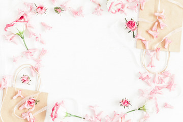 Fototapeta na wymiar Flowers composition. Gift and pink flowers on white background. Flat lay, top view