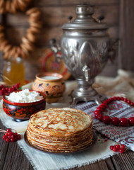 Traditional Ukrainian or Russian pancakes with cottage cheese and milk on vintage wooden table background. Traditional dishes on the holiday Carnival Maslenitsa Shrovetide .