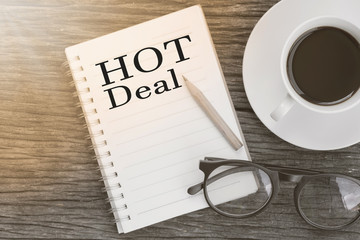 Concept Hot Deal message on notebook with glasses, pencil and co