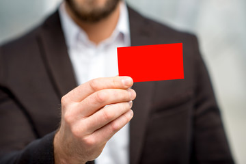 Man in the suit showing business card. Close-up view on the empty card to copy paste
